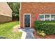 Close-up of the townhouse entrance with a black front door and manicured greenery at 4862 Park Cir, Atlanta, GA 30349