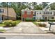 Brick townhouse showcasing a front yard with manicured landscaping and private parking space at 4862 Park Cir, Atlanta, GA 30349