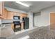 Kitchen featuring wood cabinets, black appliances, and stone-look countertops at 4862 Park Cir, Atlanta, GA 30349