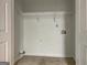 A clean laundry room with tiled floors and a wire rack for storage at 4862 Park Cir, Atlanta, GA 30349