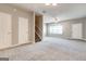 Spacious, carpeted living room with ample natural light and multiple entry points at 4862 Park Cir, Atlanta, GA 30349