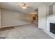Open living room with fireplace, neutral carpet, and view into kitchen area at 4862 Park Cir, Atlanta, GA 30349