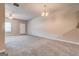 Large, bright living room with ceiling fan, plush carpet, and view into kitchen at 4862 Park Cir, Atlanta, GA 30349