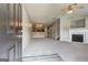 Spacious living room featuring plush carpeting, fireplace, and open access to kitchen at 4862 Park Cir, Atlanta, GA 30349