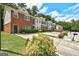 View of the townhouses with landscaped yards and private parking areas at 4862 Park Cir, Atlanta, GA 30349
