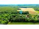 An aerial view of a large parcel of land, surrounded by lush trees with a location pin at 6830 Peeksville Rd, Mcdonough, GA 30252