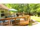 Relaxing backyard deck offers a serene outdoor space with a dining set and a grill for outdoor gatherings at 6830 Peeksville Rd, Mcdonough, GA 30252