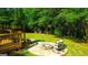 Beautiful backyard firepit area with rocking chairs, ideal for cozy outdoor entertaining and enjoying nature at 6830 Peeksville Rd, Mcdonough, GA 30252
