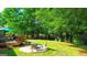 Backyard features a wooden deck, lush lawn, and mature trees creating a private outdoor space at 6830 Peeksville Rd, Mcdonough, GA 30252