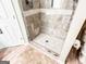 Modern bathroom boasts frameless glass shower with dual shower heads and updated fixtures at 6830 Peeksville Rd, Mcdonough, GA 30252