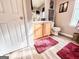 Neutral bathroom with wood-look flooring, a cherry rug, and good natural light at 6830 Peeksville Rd, Mcdonough, GA 30252