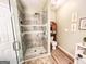 Modern bathroom boasts frameless glass shower, new tiling, and updated fixtures at 6830 Peeksville Rd, Mcdonough, GA 30252