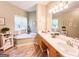 Bright bathroom with double vanity, soaking tub, and large windows providing natural light at 6830 Peeksville Rd, Mcdonough, GA 30252