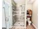 Modern bathroom boasts frameless glass shower, new tiling, and updated fixtures at 6830 Peeksville Rd, Mcdonough, GA 30252