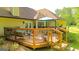Backyard wooden deck is attached to the house and contains lounge furniture and a shade umbrella at 6830 Peeksville Rd, Mcdonough, GA 30252