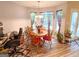 Cozy dining area with wood table, chairs, and natural light from large windows at 6830 Peeksville Rd, Mcdonough, GA 30252