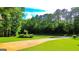 Long driveway leading to a home surrounded by large trees and a well-maintained lawn at 6830 Peeksville Rd, Mcdonough, GA 30252