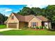 Beautiful brick home with attached garage, landscaping, and pristine lawn at 6830 Peeksville Rd, Mcdonough, GA 30252