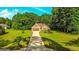 Charming brick home with a well-manicured lawn, mature trees, and a long driveway leading to an attached garage at 6830 Peeksville Rd, Mcdonough, GA 30252