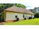 Side view of tan home with a brown roof surrounded by a well manicured lawn at 6830 Peeksville Rd, Mcdonough, GA 30252