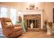Cozy living room with a brick fireplace, creating a warm and inviting atmosphere, complemented by natural light at 6830 Peeksville Rd, Mcdonough, GA 30252