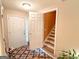 Neutral colored foyer with hardwood floors, a white door, and an open stairwell at 6830 Peeksville Rd, Mcdonough, GA 30252