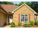 Charming entrance with a decorative front door, manicured shrubs, and lovely window shutters at 6830 Peeksville Rd, Mcdonough, GA 30252