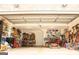Spacious garage with ample storage shelving, work bench, tools and a lawn mower at 6830 Peeksville Rd, Mcdonough, GA 30252