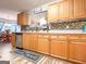 Charming kitchen featuring wood cabinets, stainless steel appliances, and decorative backsplash at 6830 Peeksville Rd, Mcdonough, GA 30252