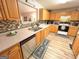 Well-equipped kitchen featuring wood cabinetry, tile backsplash and modern appliances at 6830 Peeksville Rd, Mcdonough, GA 30252