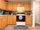 Traditional kitchen featuring wood cabinetry, modern appliances, and a doorway to another room at 6830 Peeksville Rd, Mcdonough, GA 30252