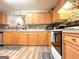 Inviting kitchen with warm wood cabinets, tiled backsplash, and a view into the dining area at 6830 Peeksville Rd, Mcdonough, GA 30252