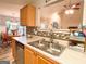 Stainless steel sink with wood cabinets and decorative backsplash open to the living and dining areas at 6830 Peeksville Rd, Mcdonough, GA 30252