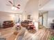 Inviting living room featuring vaulted ceilings, ceiling fan and cozy seating arrangement at 6830 Peeksville Rd, Mcdonough, GA 30252