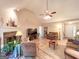 Spacious living room with a cozy fireplace, and ceiling fan, designed for comfortable and inviting living spaces at 6830 Peeksville Rd, Mcdonough, GA 30252