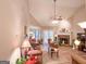 Open-concept living room with a cozy fireplace, ceiling fan, and seamless flow to the dining area at 6830 Peeksville Rd, Mcdonough, GA 30252