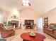 Cozy living room featuring a stone fireplace, large TV and neutral paint at 6830 Peeksville Rd, Mcdonough, GA 30252