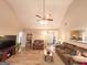 Spacious living room with an open layout, fireplace, and ceiling fan, seamlessly connecting to the rest of the home at 6830 Peeksville Rd, Mcdonough, GA 30252