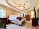 Spacious main bedroom with tray ceiling, ceiling fan, and neutral decor at 6830 Peeksville Rd, Mcdonough, GA 30252