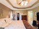 Main bedroom with a tray ceiling, ceiling fan, walk-in closet, and ensuite bathroom at 6830 Peeksville Rd, Mcdonough, GA 30252