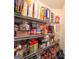 Close-up of pantry shelves stocked with a variety of food items and household goods at 6830 Peeksville Rd, Mcdonough, GA 30252
