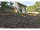 Backyard view featuring a two-story home with light siding and a wooden fence in background at 1600 Coal Shovel Ne Trl, Conyers, GA 30013