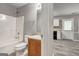 Main bathroom features a shower-tub combo, a wood vanity, and views to the kitchen at 1600 Coal Shovel Ne Trl, Conyers, GA 30013