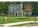 Charming two-story home featuring a well-manicured lawn and classic green shutters at 1600 Coal Shovel Ne Trl, Conyers, GA 30013