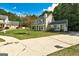 Charming two-story home with a large driveway and a well-manicured front lawn at 1600 Coal Shovel Ne Trl, Conyers, GA 30013