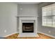 Traditional fireplace with white mantel, tile surround, and hardwood-style flooring at 1600 Coal Shovel Ne Trl, Conyers, GA 30013