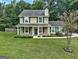 Charming two-story home with green shutters and well-manicured lawn at 1600 Coal Shovel Ne Trl, Conyers, GA 30013