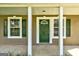 Inviting covered front porch with white columns and a freshly painted front door at 1600 Coal Shovel Ne Trl, Conyers, GA 30013
