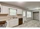 Bright kitchen showcases white cabinets, a stainless steel sink, and access to the laundry area at 1600 Coal Shovel Ne Trl, Conyers, GA 30013