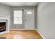 Bright living room featuring a cozy fireplace, natural light, and wood-look flooring at 1600 Coal Shovel Ne Trl, Conyers, GA 30013